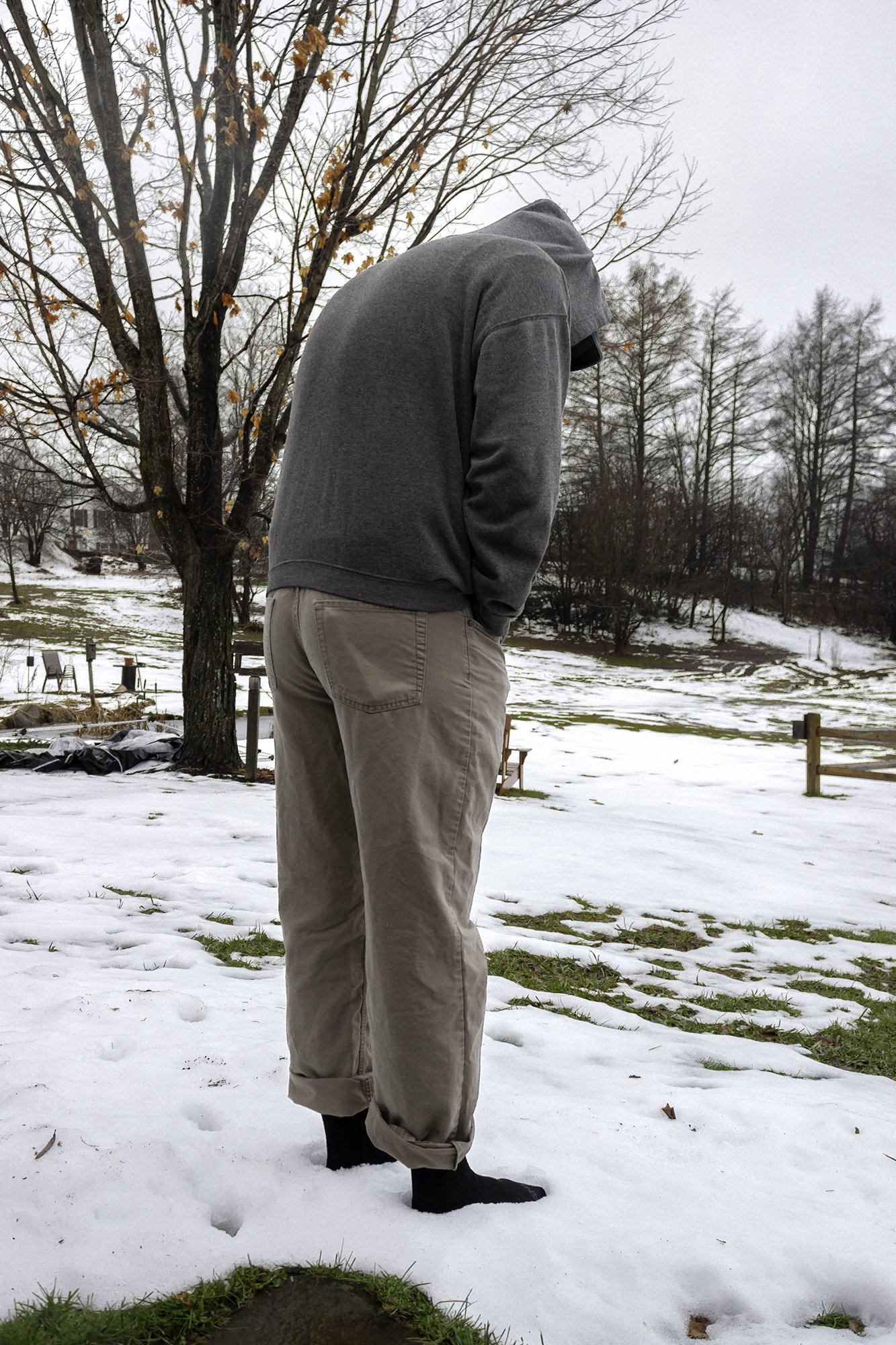 Picture of a person standing in the snow wearing socks.