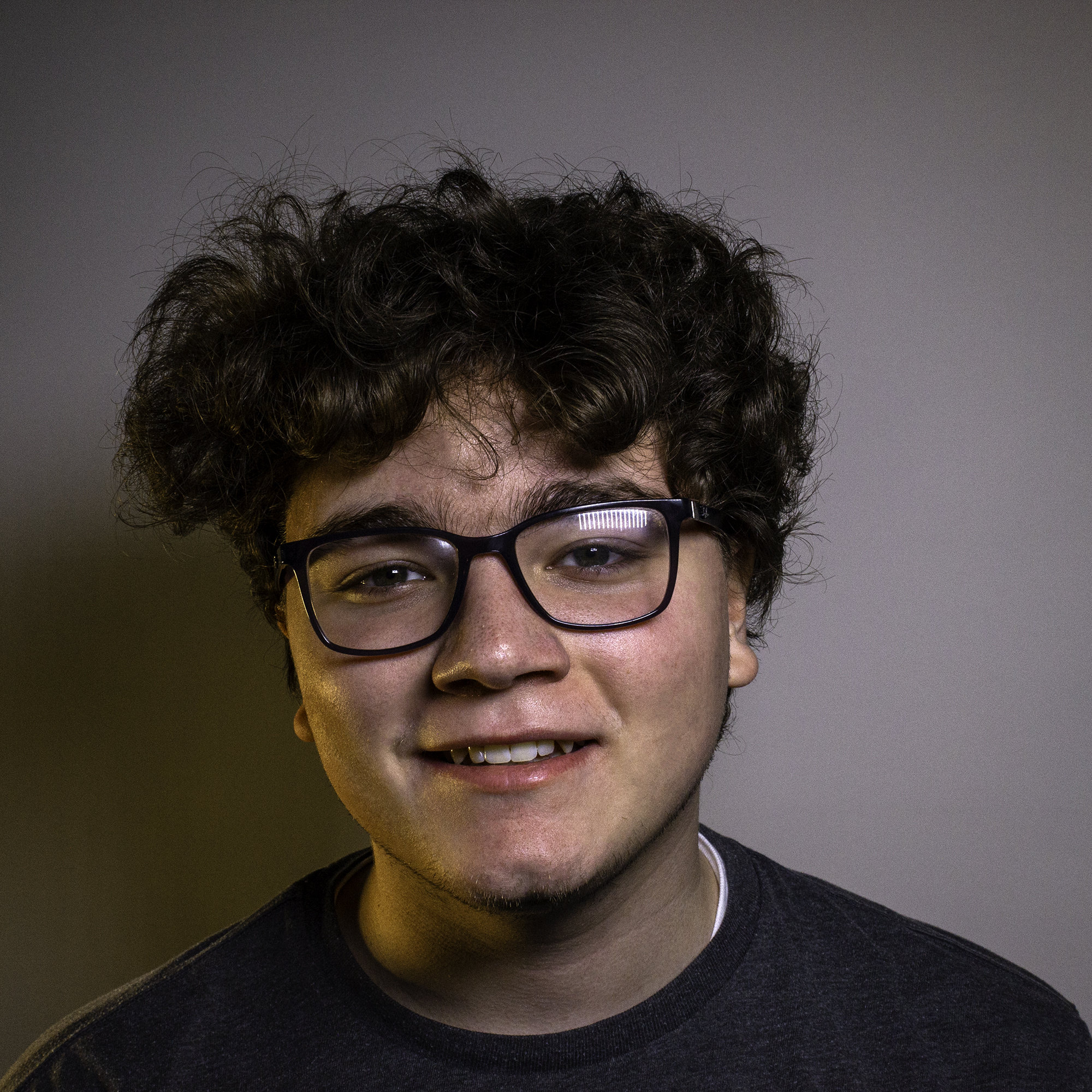 Portrait of Jacob Healt slightly smiling with his head cocked to the side.