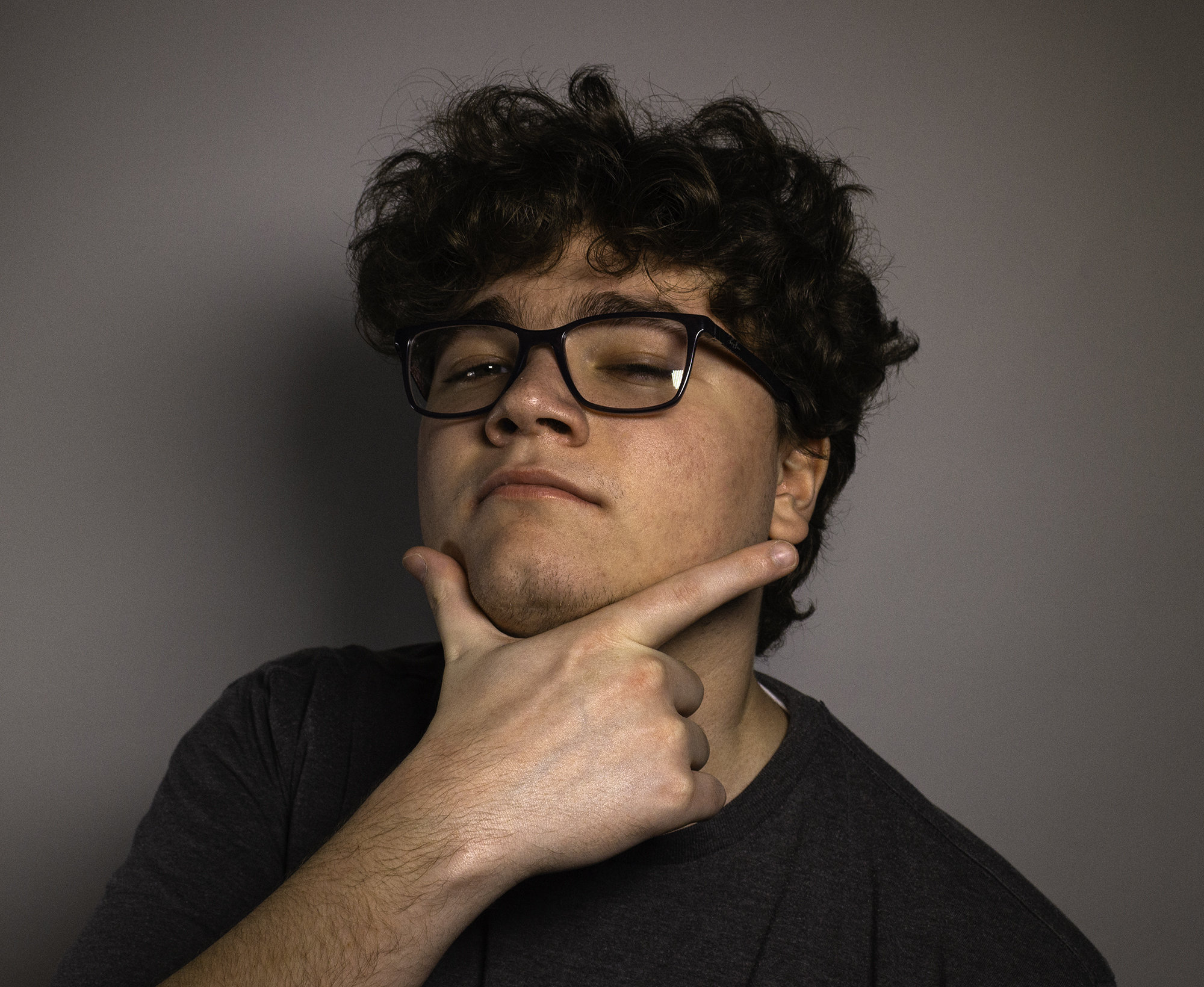 Portrait of Jacob Healt acting out a look of contemplation.