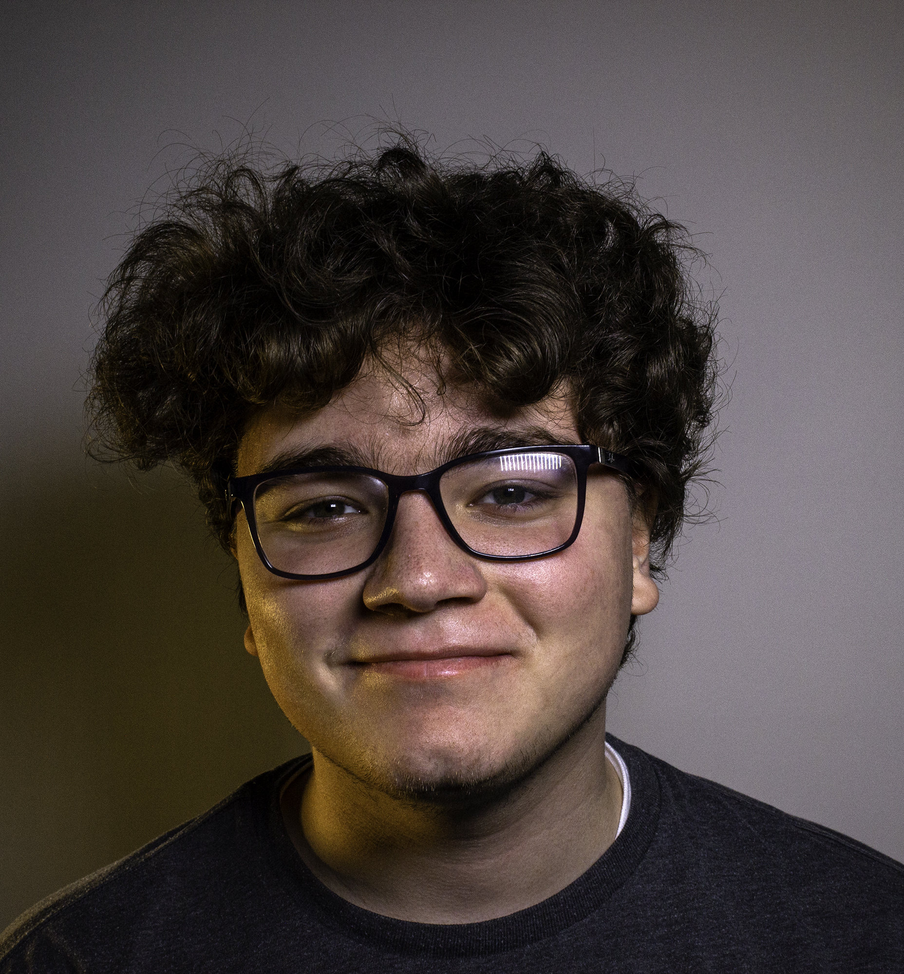 Portrait of Jacob healt with a smirk.