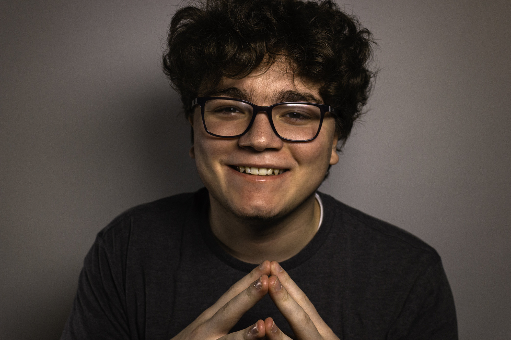 Portarit of Jacob Healt holding his hands in a pyramid shape.